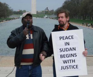 Mohamed Yahya and Jeffrey Imm Grasp Hands in Solidarity Together  on Lincoln Memorial Calling for Justice and Human Rights in Darfur