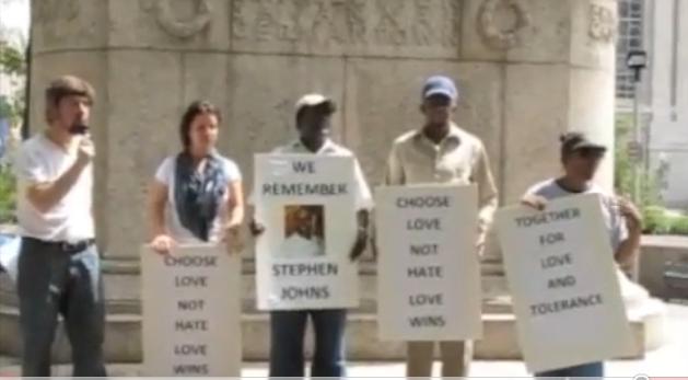  volunteers held signs reading “We Remember June 10 Attack on U.S. 
