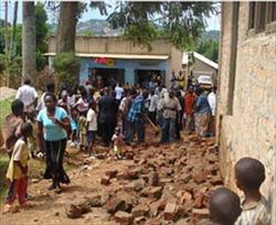 Christians examine damage to their church outside of Kampala, Uganda. (COMPASS Direct News)