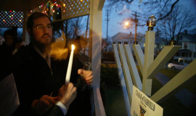 Rabbi Shlame Landa of Chabad of Fairfield prepares to light the candle on a 9 foot Menorah at Sherman Green in Fairfield. Sun. Dec. 13, 2009. (Connecticut Post/ Phil Noel/ Staff photographer)