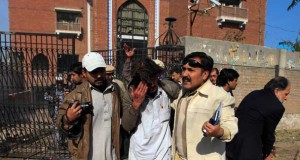 Journalists assist a man who was injured in a suicide bomb attack at the site at the gate of the Press club in Peshawar, located in NWFP on December 22, 2009. (Reuters )