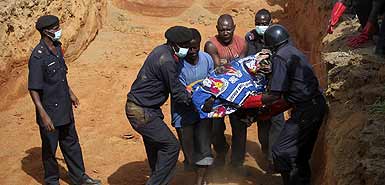 Image of March 7, 2010 Attack Aftermath as Bodies were Gathered (Photo: Akintunde Akinleye/Reuters)