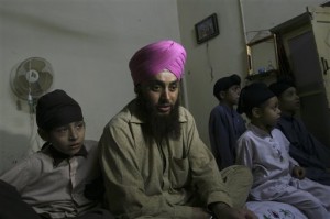 AP: "In this photo made on March 19, 2010, Surjeet Singh, from Pakistan's Sikh community, sits with family members after his release in Peshawar, Pakistan. Singh, who had been kidnapped for ransom by alleged militants, was freed after 42 days as a result of a crackdown operation by security forces" (AP Photo/Mohammad Sajjad)