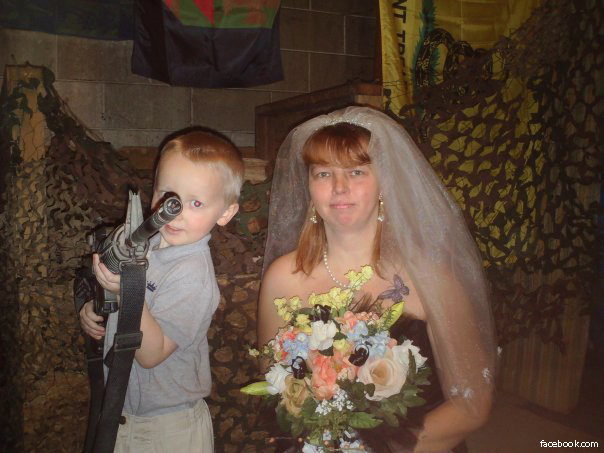 Poor Child being given Automatic Weapon by Hutaree Militia Suspects (Gadsden Flag on Right)