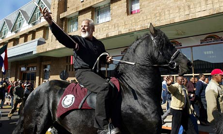 Guardian: "Eugene Terre’Blanche waves to his supporters after he was released from prison in Potchefstroom in June 2004 after he had served part of a five-year sentence for the attempted murder of a black security guard." (Photograph: Alexander Joe/AFP/Getty Images)