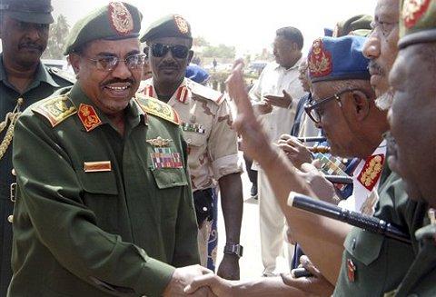 "Sudanese President Omar al-Bashir, in full military dress, greets army officers as as he visits the military hospital, in Khartoum, 22 April 2010" (Photo: AP)