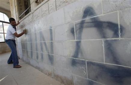 Reuters: "A Palestinian cleans near a Star of David that was painted in the Bilal Ibn Rabah mosque in the West Bank village of Hawara near Nablus April 14, 2010." (Photo: REUTERS/Abed Omar Qusini)