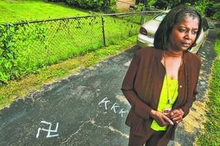 The Tennessean: "Carla Gordon woke up at her home Wednesday morning to a Nazi swastika and 'KKK' painted on her driveway in Madison" (Photo: JOHN PARTIPILO / THE TENNESSEAN) 