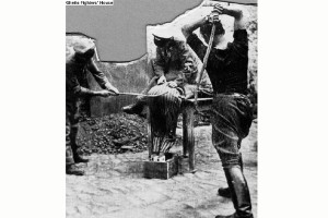 Three of the SS staff flogging an inmate in a Nazi camp. The inmate is bent over a special bench designed for the purpose, with one of the SS sitting on his back. (Source: Ghetto Fighters Archives. Catalog No. 10390)