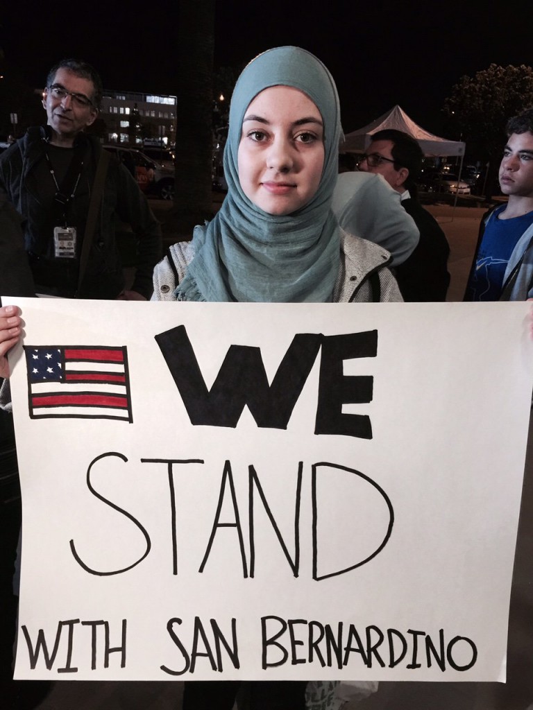 Muslim woman Samar Natour - standing friends with the victims of San Bernardino terrorist attack - "We are here to show support and for there to be a Muslim presence and to show that the violence is not what our religion is about " (Source: Newsweek)